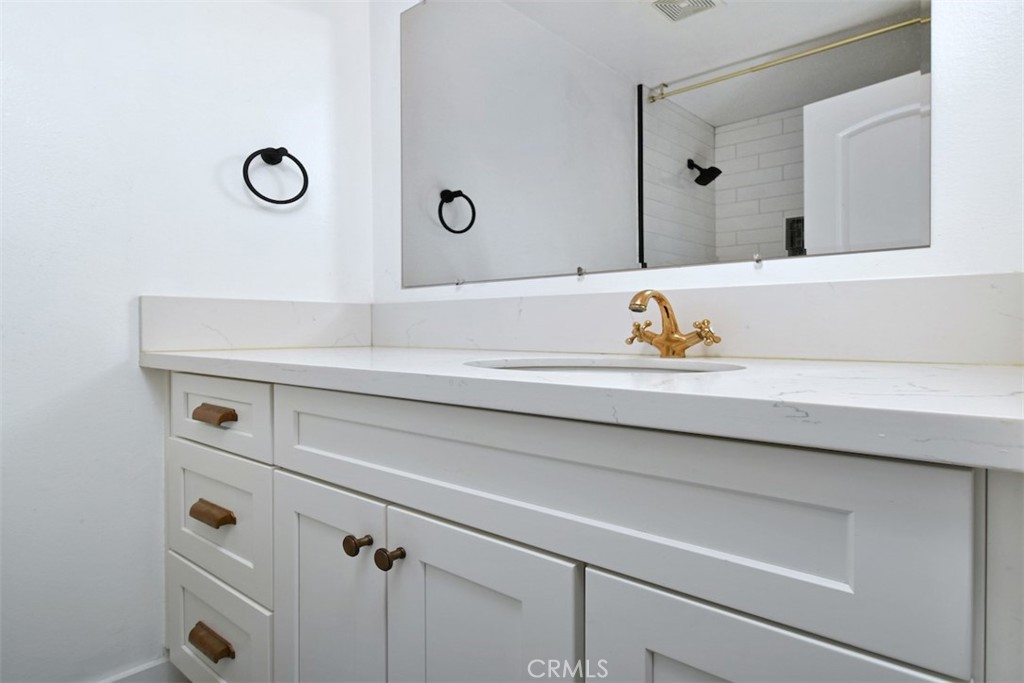 28159 Robin Avenue Saugus, CA 91350 - Photo 28 of 42 a bathroom with a sink and a mirror