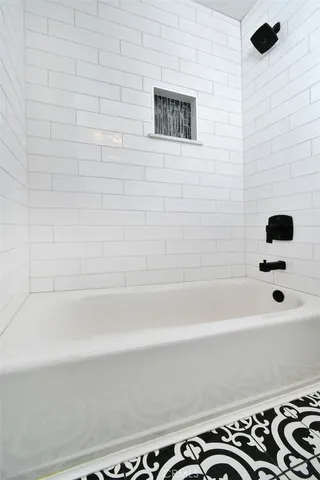 a bathroom with a bathtub and a shower