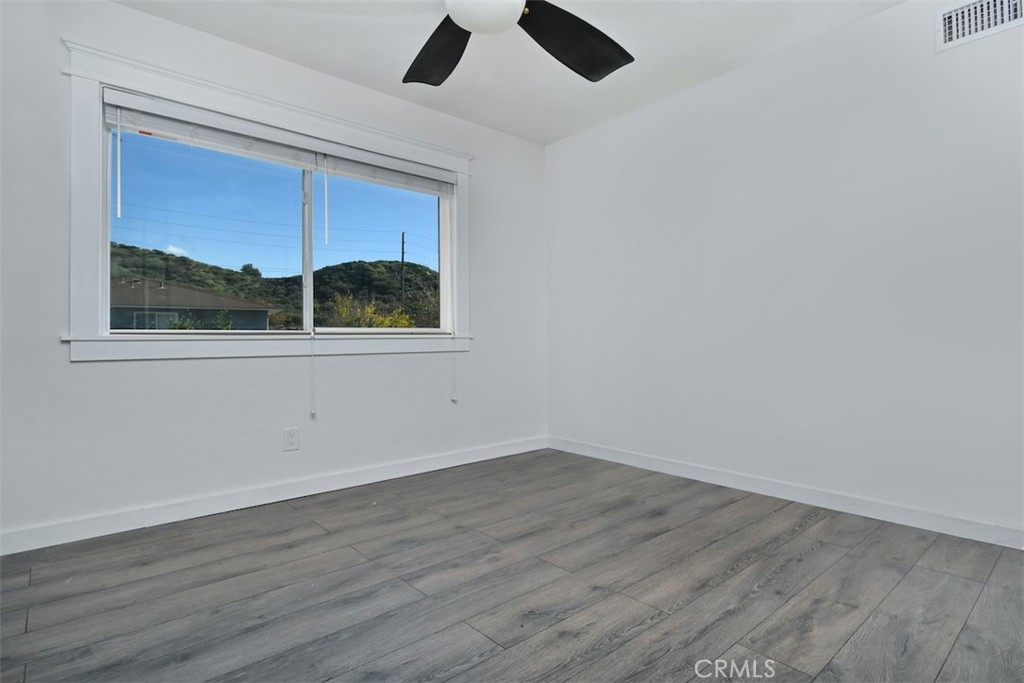 28159 Robin Avenue Saugus, CA 91350 - Photo 33 of 42 an empty room with wooden floor and windows