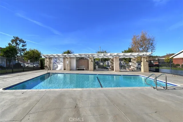 a view of a swimming pool with a lawn chairs and couches
