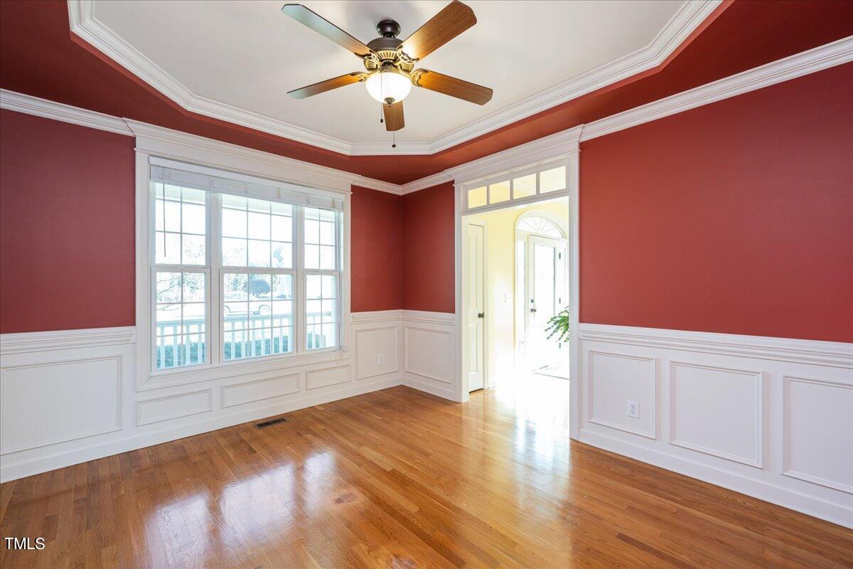 2117 Conroy Way Willow Spring, NC 27592 - Photo 20 of 38 Waiscoting, trey ceiling, crown moulding. This dining room is ready for entertaining!