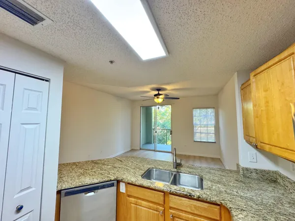 a kitchen with stainless steel appliances granite countertop a refrigerator stove and sink