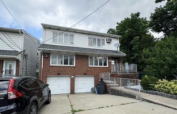 689 Fairview Avenue, Unit 1 Fairview, NJ 07022 - Photo 1 of 1 a front view of a house with a garden