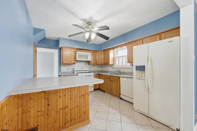 a kitchen with granite countertop a sink stainless steel appliances and cabinets