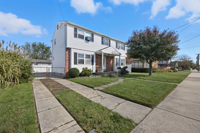 an aerial view of multiple houses with yard