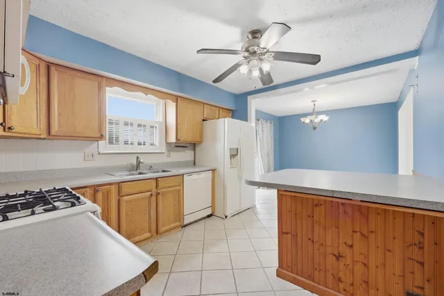 a kitchen with granite countertop a sink stainless steel appliances and cabinets