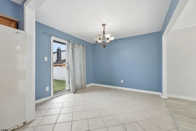 a view of an empty room with a chandelier