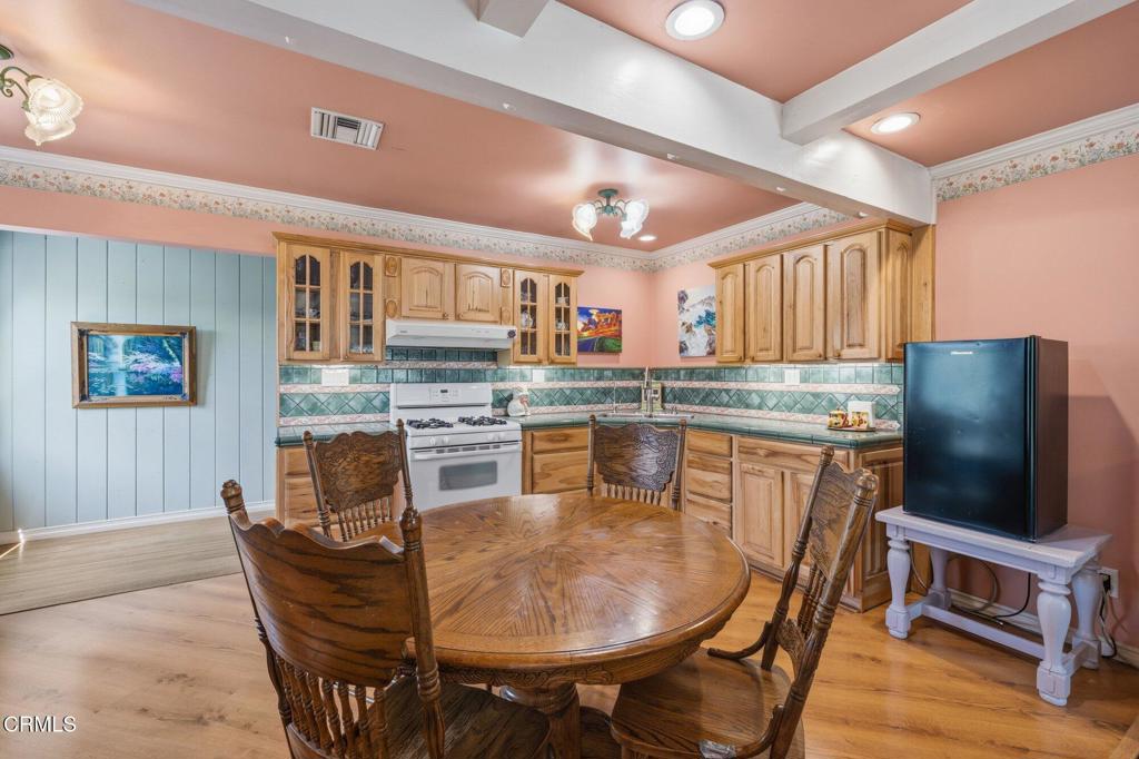 13934 Aztec Street Sylmar, CA 91342 - Photo 24 of 41 a kitchen with stainless steel appliances granite countertop a table chairs and a refrigerator