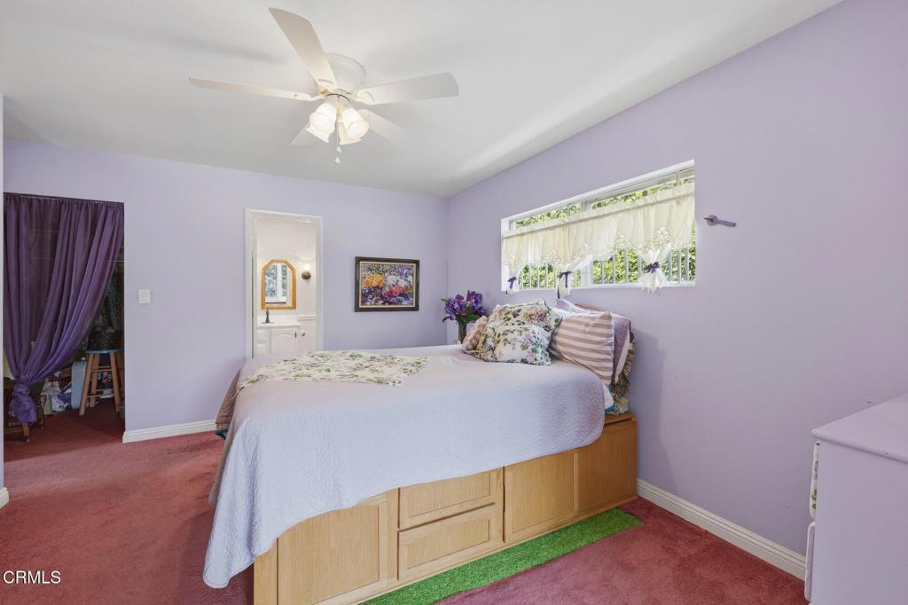 13934 Aztec Street Sylmar, CA 91342 - Photo 29 of 41 a bed room with a bed and a chandelier
