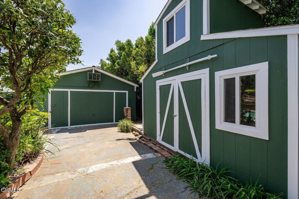 13934 Aztec Street Sylmar, CA 91342 - Photo 35 of 41 a front view of a house with a yard and potted plants