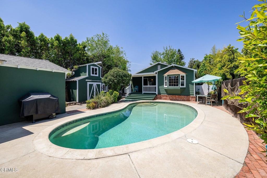 13934 Aztec Street Sylmar, CA 91342 - Photo 39 of 41 a view of a house with pool fire pit and trees in the background