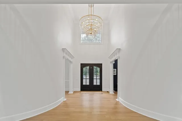 a kitchen with white cabinets a sink dishwasher and a stove with wooden floor