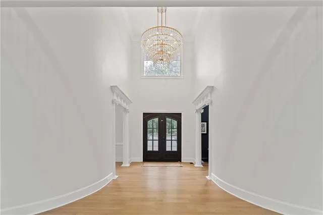 a kitchen with white cabinets a sink dishwasher and a stove with wooden floor