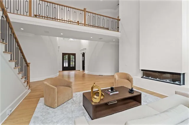 a dining room with furniture a chandelier and a large window