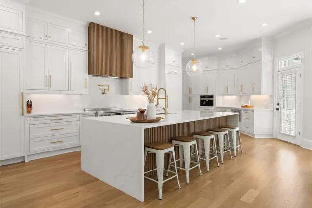 a living room with furniture two windows and a potted plant