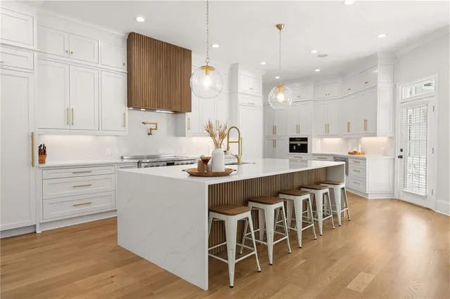 a living room with furniture two windows and a potted plant
