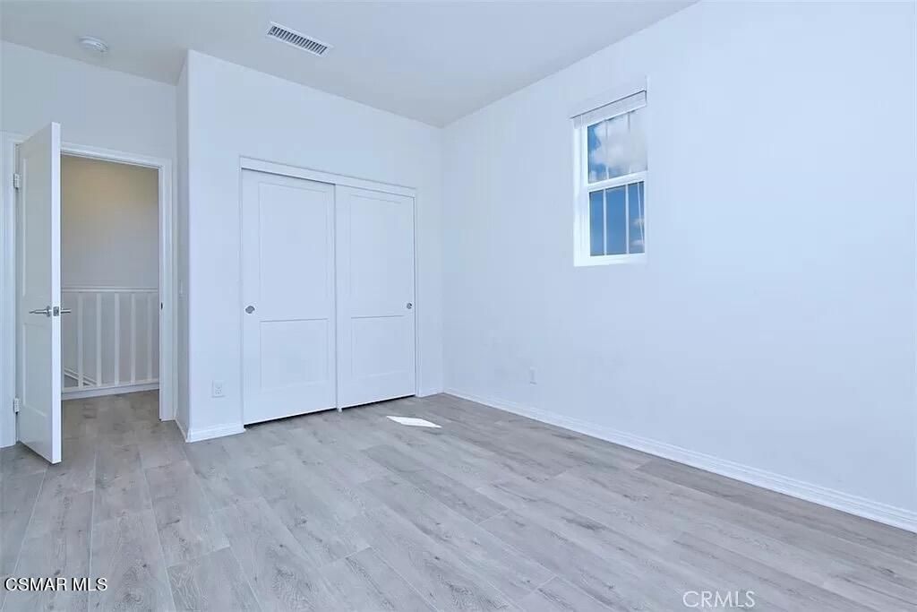 207 Morro Way, Unit 3 Simi Valley, CA 93065 - Photo 16 of 31 an empty room with wooden floor