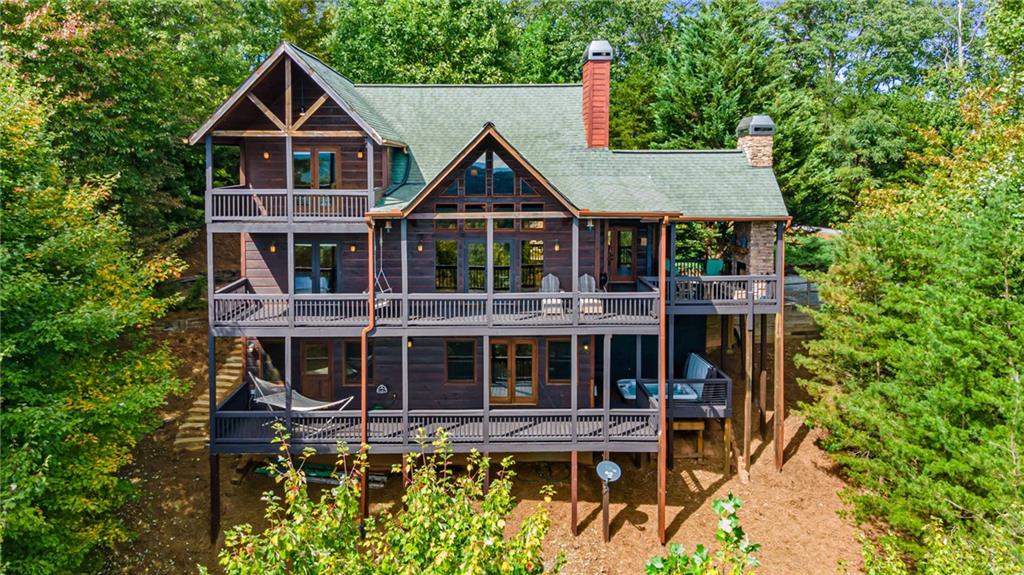 831 Racoon Road Blue Ridge, GA 30513 - Photo 1 of 1 a front view of a house with wooden fence and plants