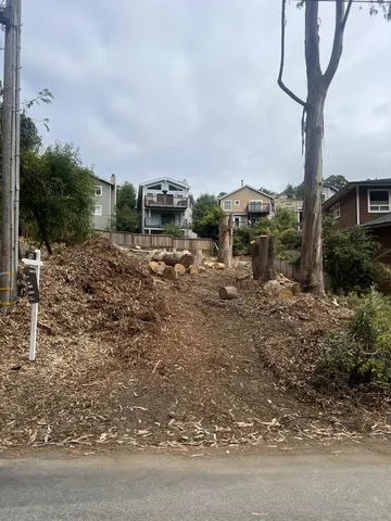 a view of a town with barn house in the background
