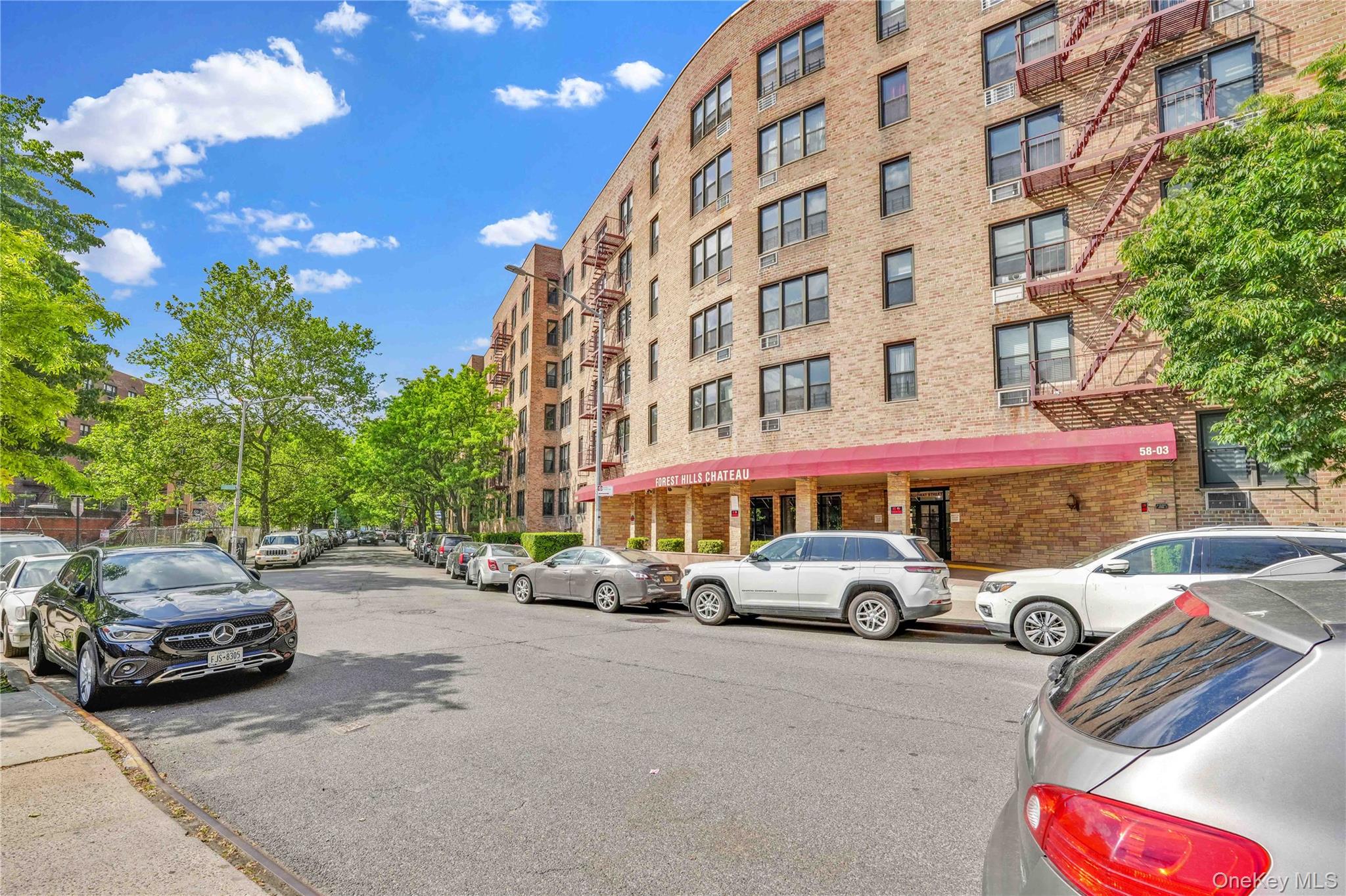 58-03 Calloway Street, Unit 5A Queens, NY 11368 - Photo 2 of 19 a front view of a building with parking space