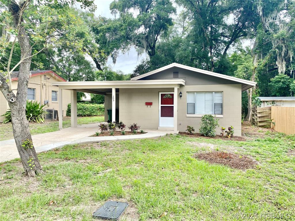 205 West Division Street DeLand, FL 32720 - Photo 1 of 15 a view of a yard with a house and a large tree