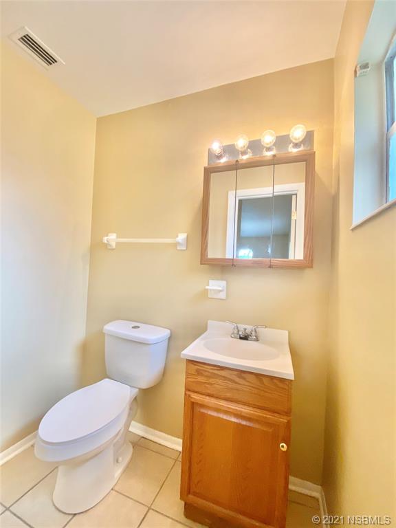 205 West Division Street DeLand, FL 32720 - Photo 12 of 15 a bathroom with a toilet sink and mirror