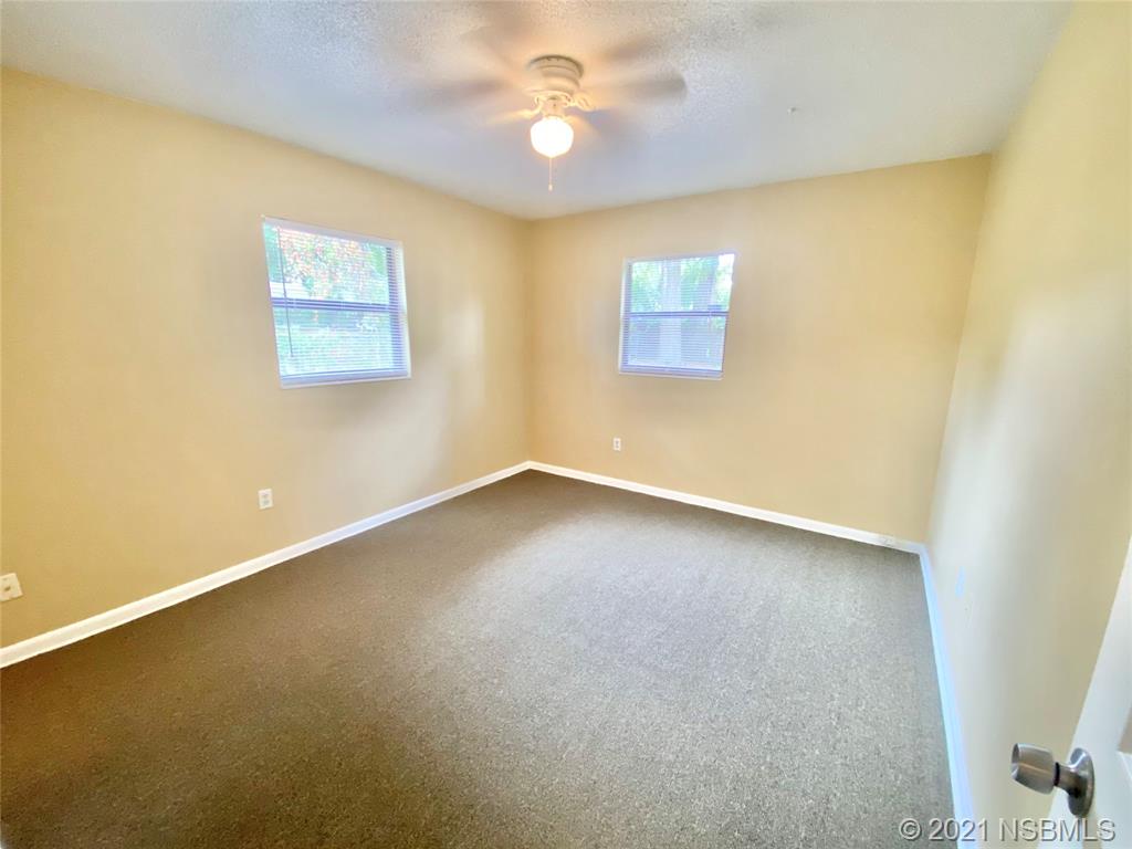 205 West Division Street DeLand, FL 32720 - Photo 10 of 15 an empty room with a ceiling fan and a window