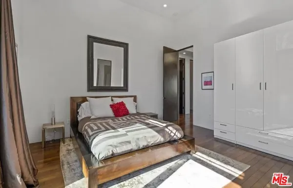 a bedroom with a bed and a mirror