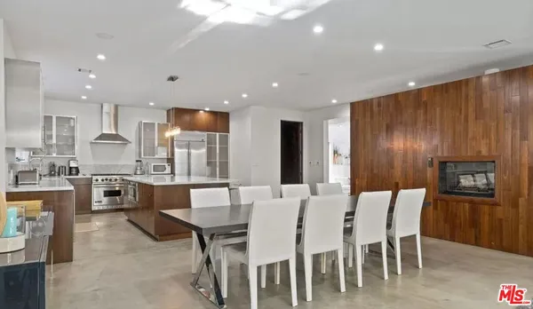 a large kitchen with a table and chairs