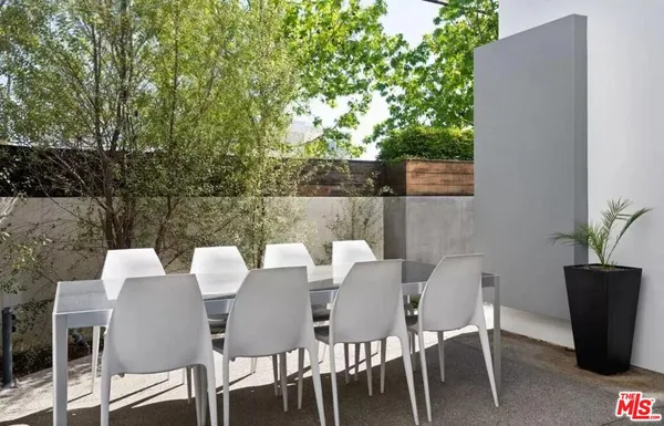 a view of a dining table and chairs in the patio