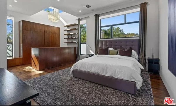 a bedroom with a large bed and a large window