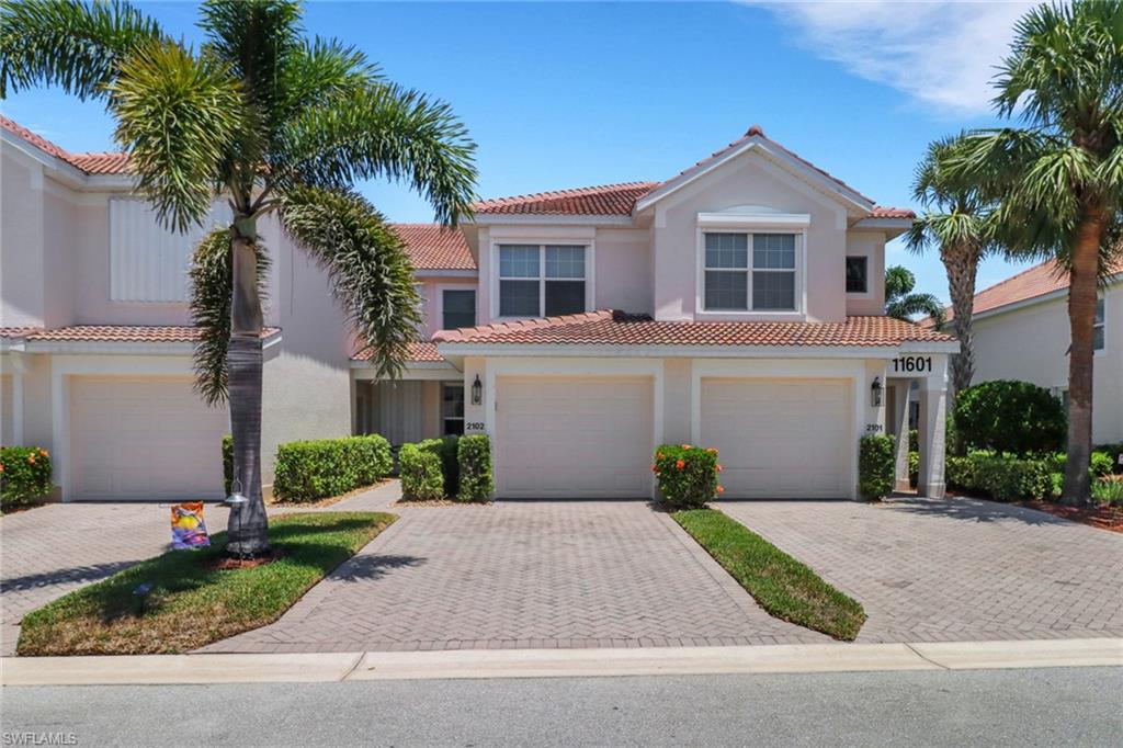 11601 Navarro Way, Unit 2102 Fort Myers, FL 33908 - Photo 1 of 25 Mediterranean / spanish house featuring an attached garage, stucco siding, decorative driveway, and a tiled roof