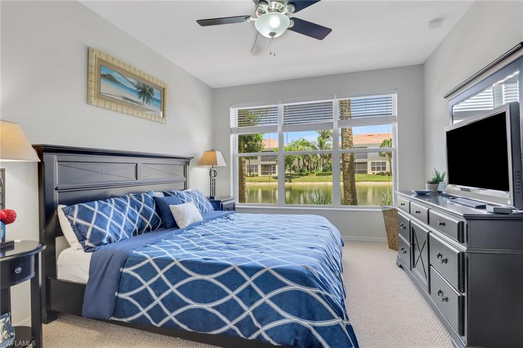11601 Navarro Way, Unit 2102 Fort Myers, FL 33908 - Photo 12 of 25 Bedroom featuring light colored carpet and a ceiling fan
