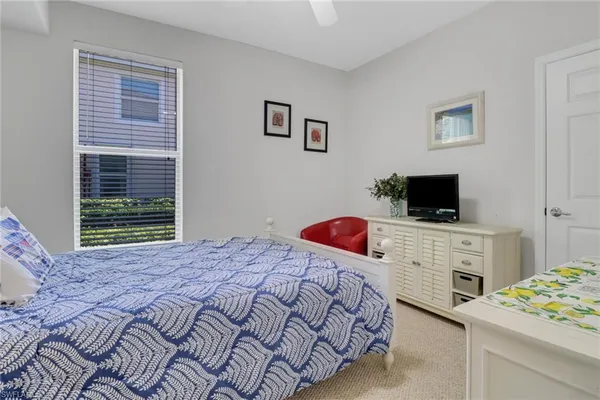 a bedroom with a bed and flat screen tv
