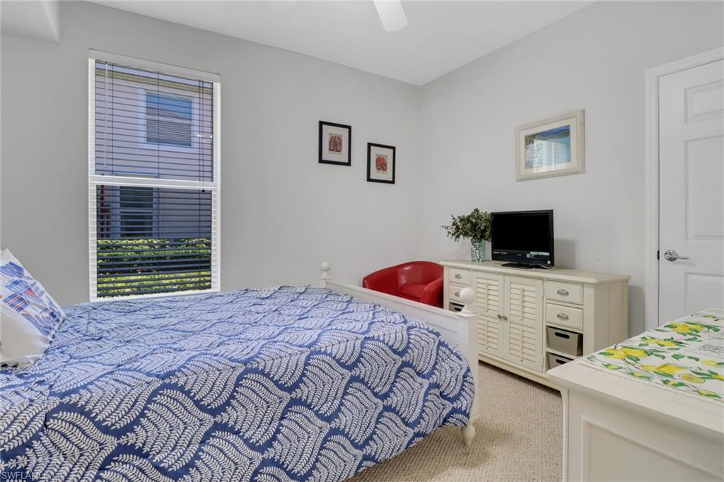11601 Navarro Way, Unit 2102 Fort Myers, FL 33908 - Photo 16 of 25 Bedroom featuring light colored carpet, ceiling fan, and multiple windows