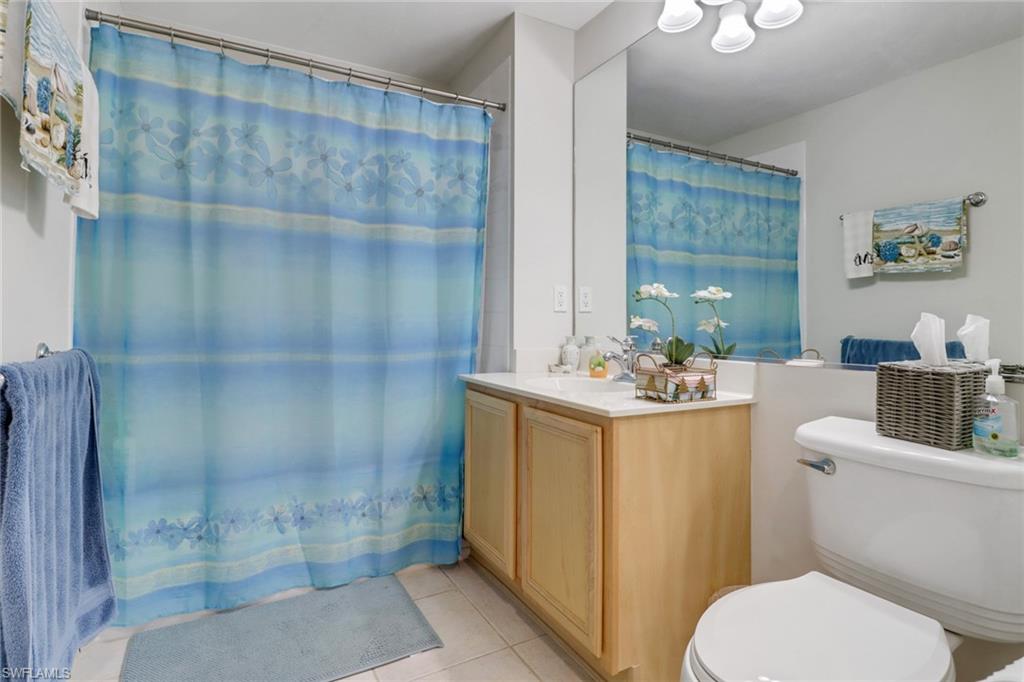 11601 Navarro Way, Unit 2102 Fort Myers, FL 33908 - Photo 18 of 25 Full bathroom featuring light tile patterned floors, a shower with curtain, and vanity