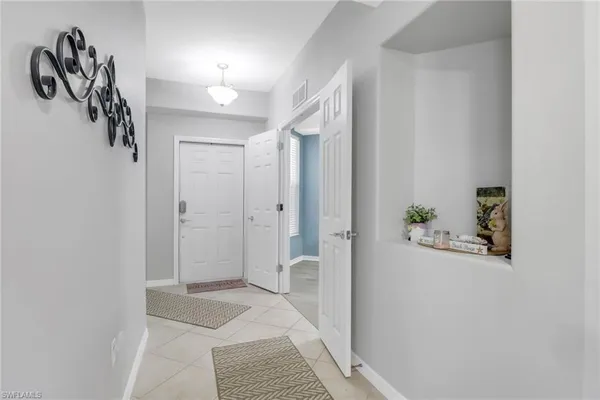 a view of a hallway with closet and a potted plant