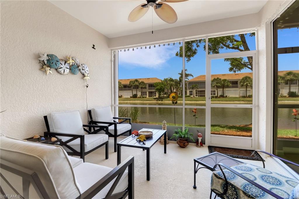 11601 Navarro Way, Unit 2102 Fort Myers, FL 33908 - Photo 22 of 25 Sunroom / solarium with a textured wall and a water view