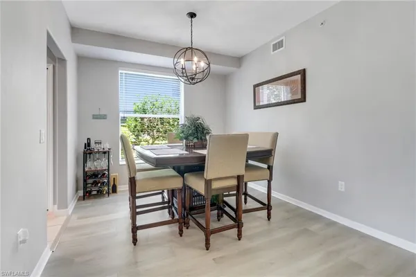 a view of a dining room with furniture and a chandelier