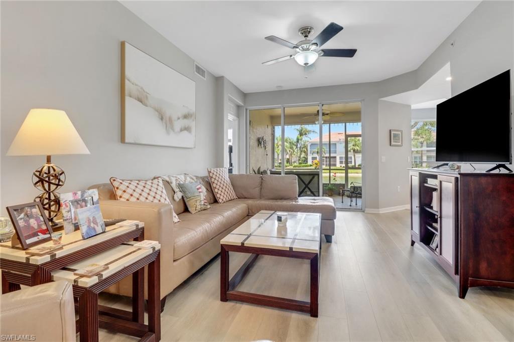 11601 Navarro Way, Unit 2102 Fort Myers, FL 33908 - Photo 9 of 25 Living room with light wood-style floors and a ceiling fan