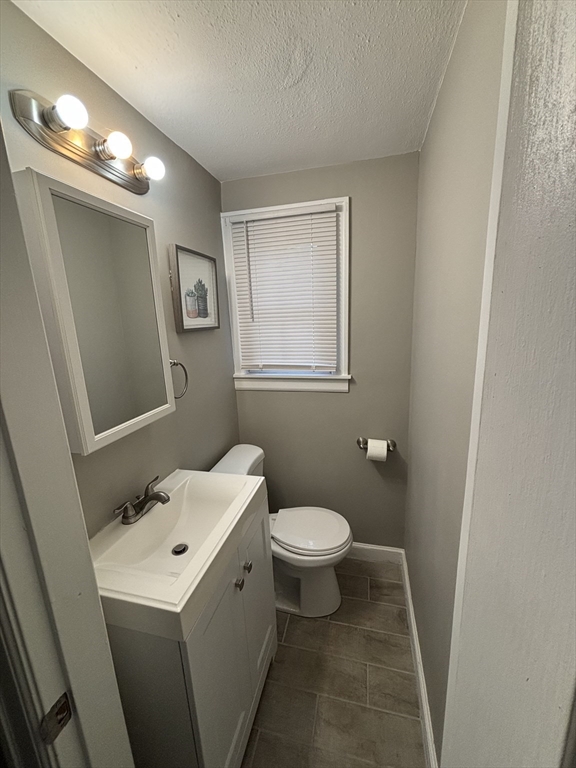 253 Gillette Avenue Springfield, MA 01118 - Photo 12 of 26 a bathroom with a sink toilet and a mirror