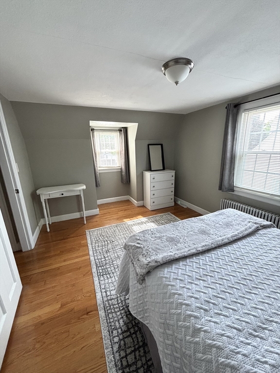253 Gillette Avenue Springfield, MA 01118 - Photo 18 of 26 a bedroom with a bed and wooden floor
