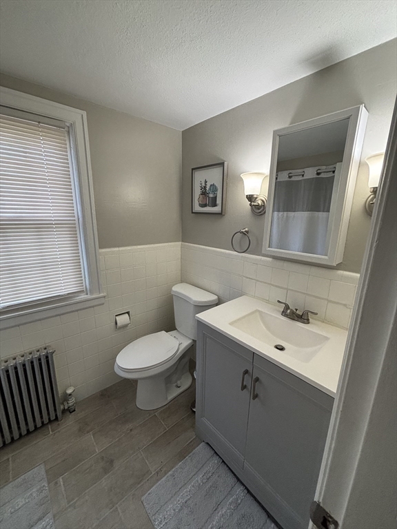 253 Gillette Avenue Springfield, MA 01118 - Photo 22 of 26 a bathroom with a toilet sink and mirror