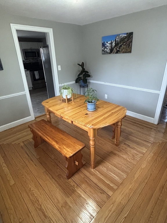 253 Gillette Avenue Springfield, MA 01118 - Photo 4 of 26 a room with wooden floor and table