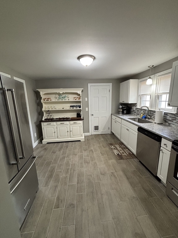 253 Gillette Avenue Springfield, MA 01118 - Photo 8 of 26 a kitchen with stainless steel appliances granite countertop a stove a refrigerator and a sink