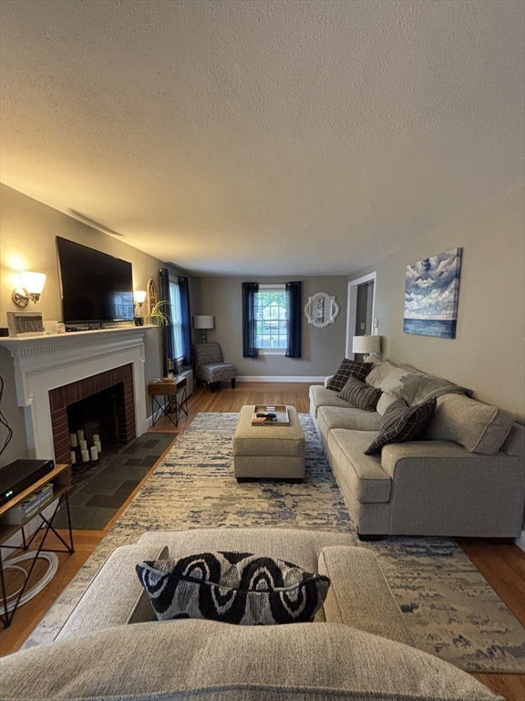 253 Gillette Avenue Springfield, MA 01118 - Photo 9 of 26 a living room with furniture and a fireplace