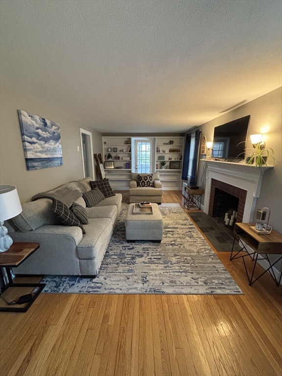 253 Gillette Avenue Springfield, MA 01118 - Photo 10 of 26 a living room with furniture and a fireplace