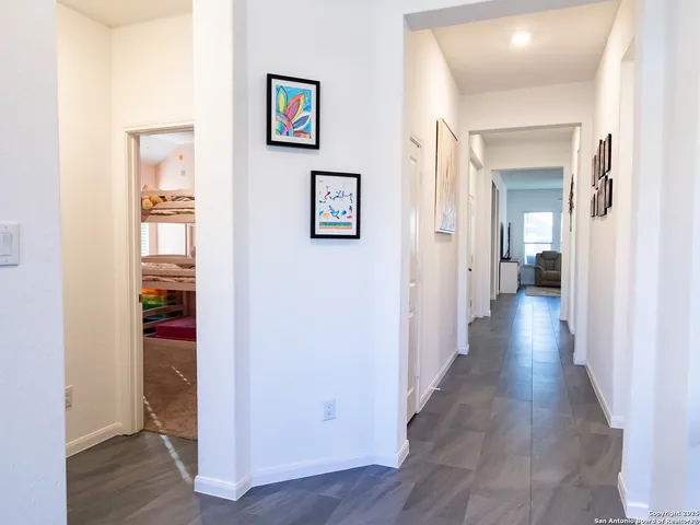 a view of a hallway with wooden floor and closet