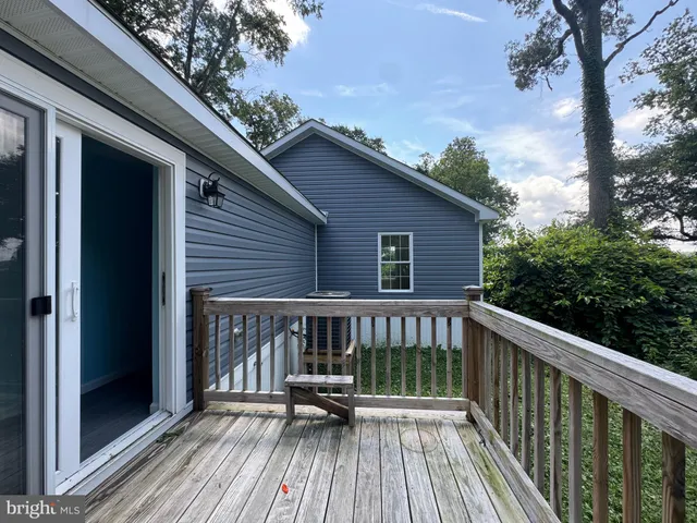 a view of a room with wooden floor and window
