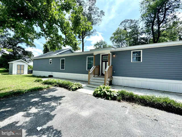 a front view of a house with a yard and a garage